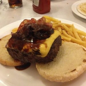 hamburger on a bun with cheese and bacon