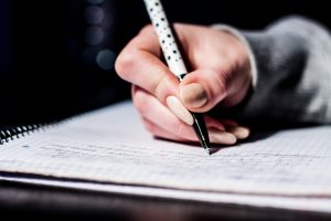 woman's hand making notes