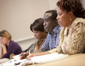 class with 4 persons paying attention