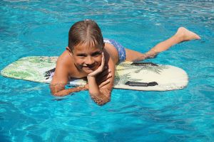 boy on surfboard in water