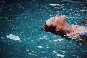 woman lying on back in water