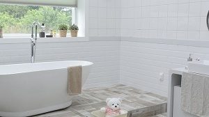 white bathroom with bath tub and window