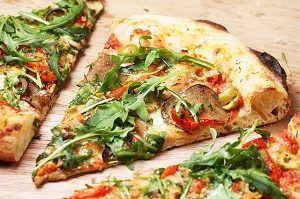 slices of pizza with arugula