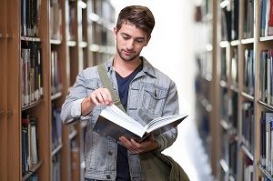 student reading book in library