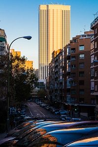 street with cars and large building in background in madrid