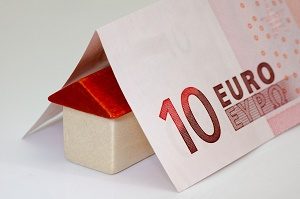toy house with 10 euro note folded over it