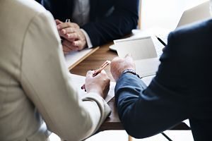 three people discussing contract