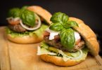 two hamburgers with basil on top