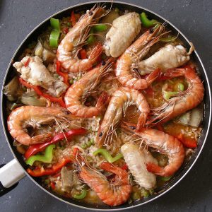 seafood paella with shrimp on top