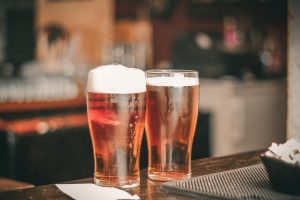 two glasses of beer on the bar