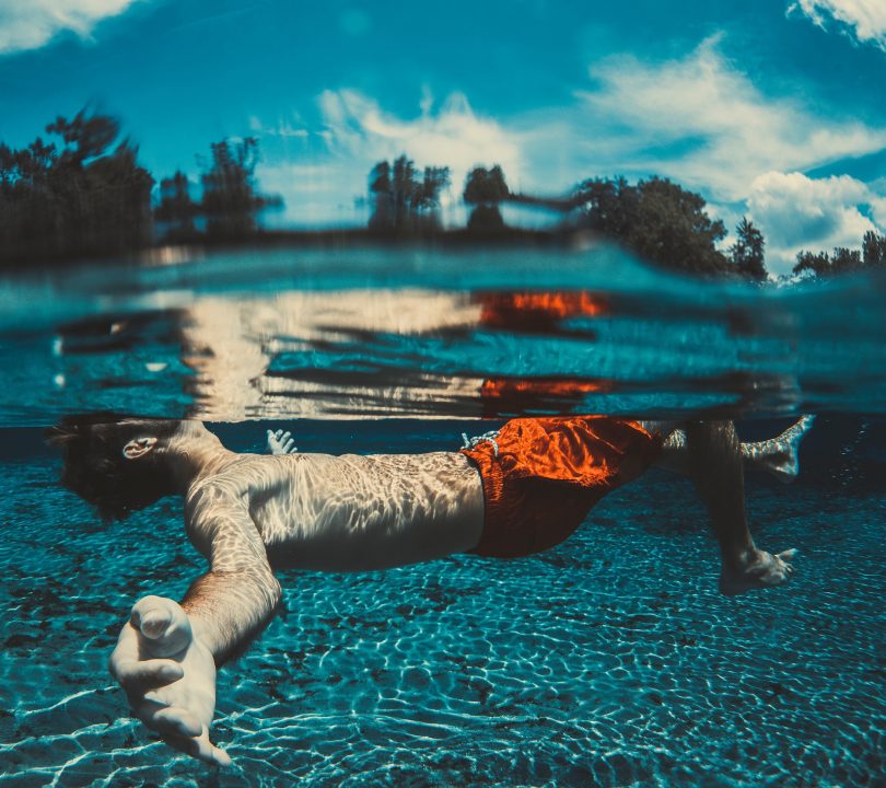 man in red trunks in pool