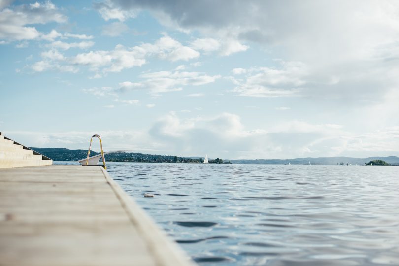 edge of swimming pool overlooking water