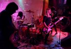 band with female singer in purple light
