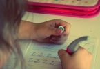 child learns to write letter Z