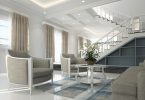 living room with light coloured furniture and white stairs