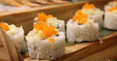 sushi with fish roe on wooden plate