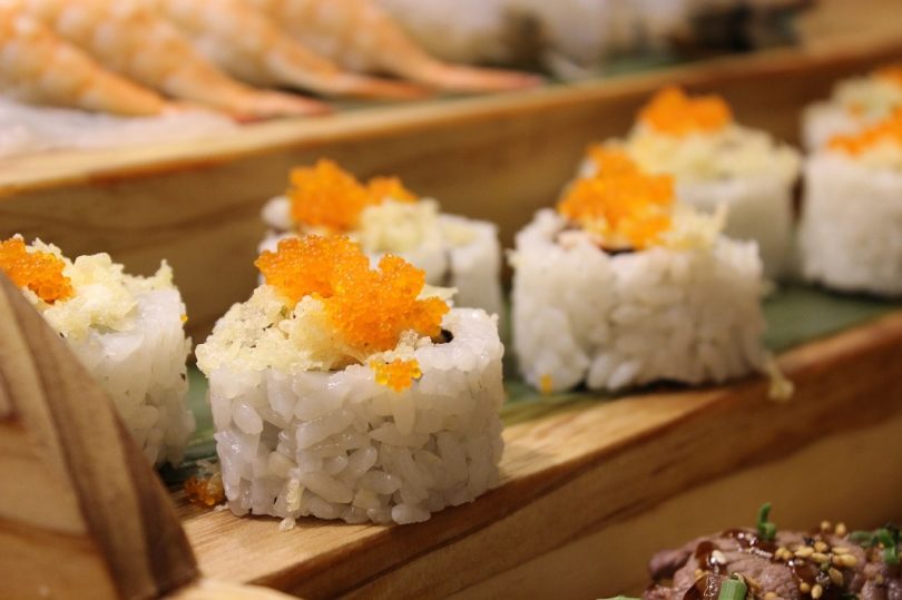 sushi with fish roe on wooden plate