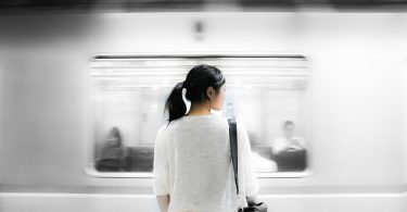 back of asian woman in train station