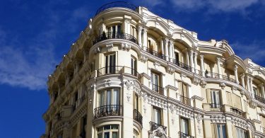 spanish building, light coloured with small balconies