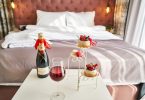 romantic hotel room with champagne and little cakes