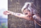 happy lady with tattoo on lower arm