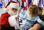 santa claus high fives child