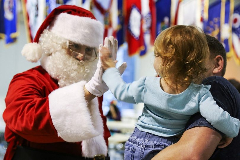 santa claus high fives child