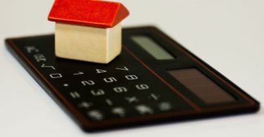 calculator with small white house and red roof