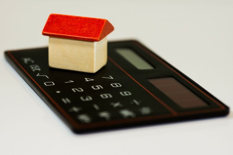 calculator with small white house and red roof