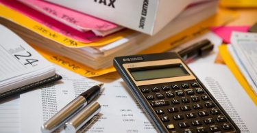 tax book, pen, papers and calculator