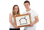 young couple holding drawing of a house
