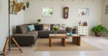 living room with brown couch and wooden tables
