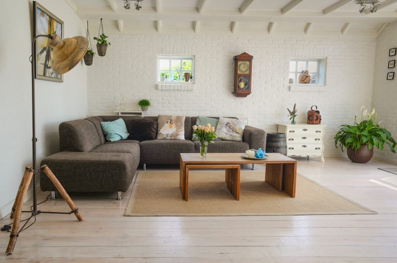 living room with brown couch and wooden tables